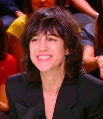 Charlotte Gainsbourg ose la mini-robe rouge en dentelle dorée Saint Laurent à 6 500 euros et enflamme la Fashion Week