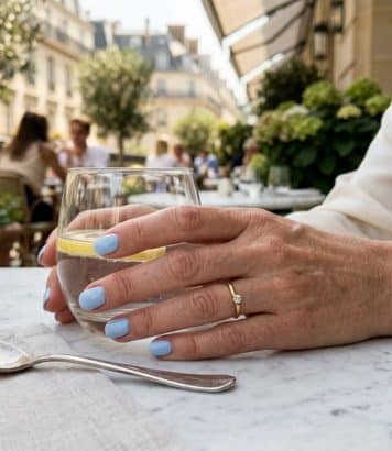 At 51, Charlize Theron tries pastel blue French manicure and takes years off her hands