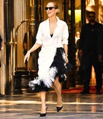 Céline Dion sublime en jupe Dior à plumes noires et blanches devant le Royal Monceau à Paris